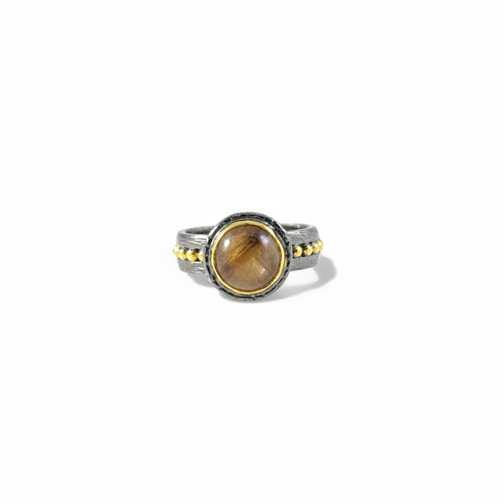 Handmade oxidised silver ring with brown rutilated quartz and gold bezel.